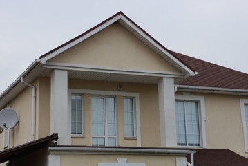  house with windows on a brown wall 