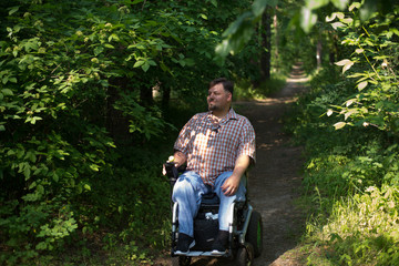 man in a wheelchair in a forest