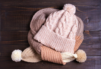 Fototapeta na wymiar Handmade knitted woolen hat and scarf, cold season concept. Women winter warm accessories. Flat lay, high angle view