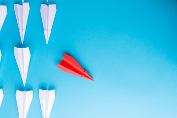 Red plane and white following him. Blue background