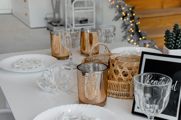 A table set with golden and glass decor for Christmas New year and lights on a background