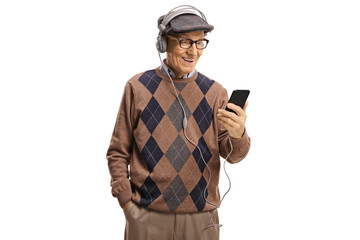 Elderly man listening to music from a mobile phones with headphones