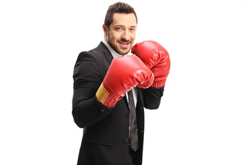 Businessman with red boxing gloves looking at the camera