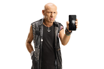 Sad punk holding his broken mobile phone