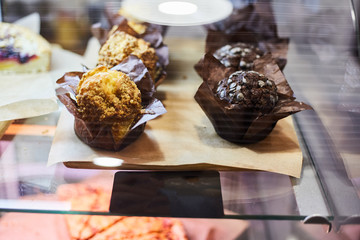 Muffins in a shop window of a pastry shop. 