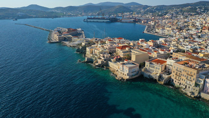 Obraz premium Aerial drone photo of pictruesque district built by the sea of Vaporia in main town of Syros or Siros island Ermoupolis near famous church of Agios Nikolaos, Cyclades, Greece