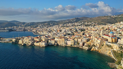 Fototapeta na wymiar Aerial drone photo of picturesque district built by the sea of Vaporia in main town of Syros or Siros island Ermoupolis and famous church of Agios Nikolaos, Cyclades, Greece