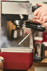 Barista making a hot drink in a coffee shop