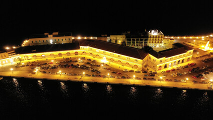 Fototapeta na wymiar Aerial drone night shot of famous port and illuminated town of Ermoupolis in island of Syros or Siros, Cyclades, Greece