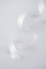 Silver curled ribbon with shimmer on white