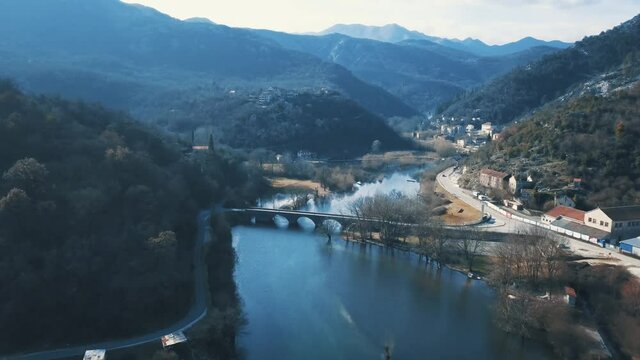 Beautiful Landscape of Crnojevica River Settlement and Old Stone Bridge. Autumn River Landscape. River and Hills. Rijeka Crnojevića.
