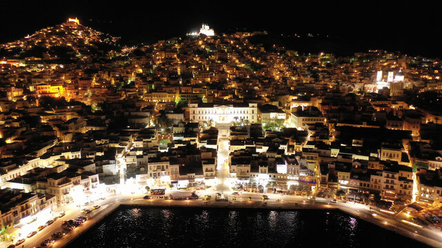 Aerial drone night shot of neoclassic landmark building of Ermoupolis town city hall in Miaouli square, Syros or Siros island, Cyclades, Greece - Powered by Adobe