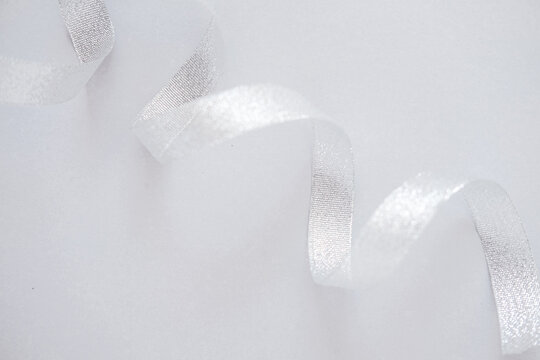 Silver curled ribbon with shimmer on white