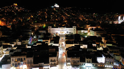 Aerial drone night shot of neoclassic landmark building of Ermoupolis town city hall in Miaouli square, Syros or Siros island, Cyclades, Greece