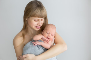 first photo shoot. mother holds a newborn in her arms