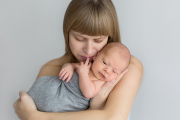 first photo shoot. mother holds a newborn in her arms