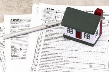 Tax form business financial concept: return tax form  With A Miniature House