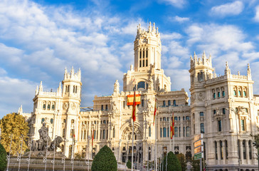 Fototapeta na wymiar Cybele Palace (Palacio de Cibeles) and Cibeles fountain in Madrid at golden hour