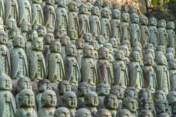 Rows of old Jizo Bodhisattva (Bosatsu) statues grouped near Jizo-do Hall at Haze-dera temple or Hase-kannon temple. Located in Kamakura, Kanagawa Prefecture, Japan