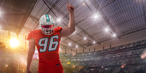 American football players on professional stadium on sunset.