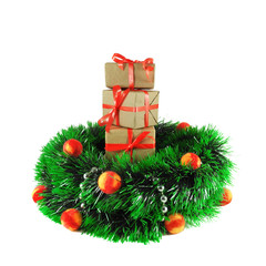 Gift boxes packed in craft paper with red ribbon placed on top of each other inside Christmas wreath decorated by felted balls and beads. Isolated on white background. Celebration and greeting concept