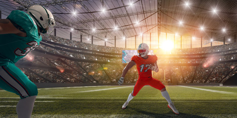 American football players on professional stadium on sunset.