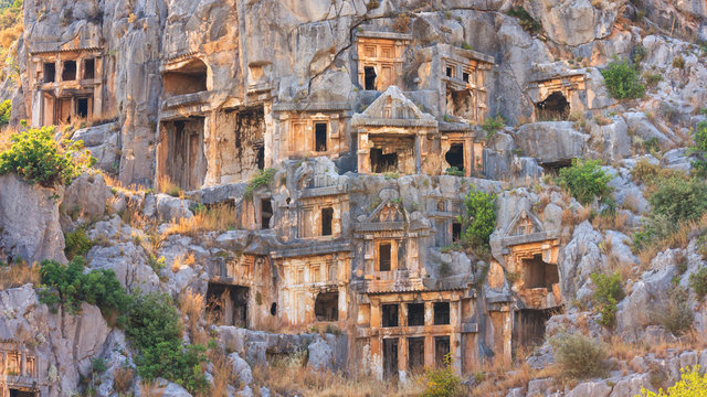 Summer mediterranean cityscape - view of the ruins of ancient Greek tombs in the ancient city of Myra, near the Turkish town of Demre, Antalya Province in Turkey