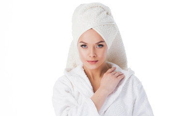 Beauty treatments after the bath. Portrait of a young beautiful woman in a Terry robe and with a...