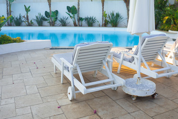 Sun loungers by the pool, a comfortable luxury holiday in the resort.