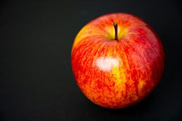 red apple on black background