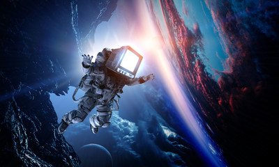 Obraz na płótnie Canvas Monitor headed astronaut . Mixed media