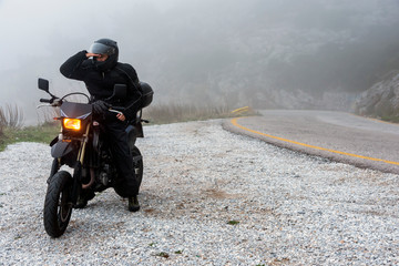 Rider trying to see through the fog on an adventure ride on the mountains