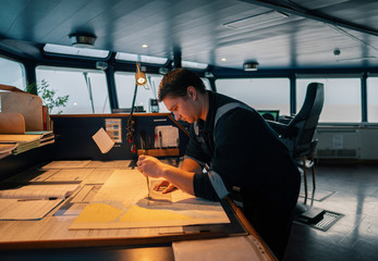 Marine navigational officer during navigational watch on Bridge . He does chart correction of nautical maps and publications. Work at sea