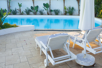 Sun loungers by the pool, a comfortable luxury holiday in the resort.