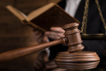 Justice and law concept, Male judge in a courtroom striking the gavel