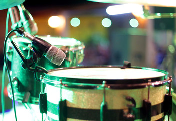 Microphone directed at snare drum in recording studio