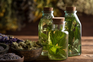 Fresh herbs and oils, wooden table background
