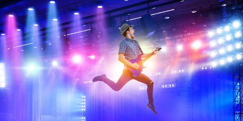 Guitarist at concert. Mixed media