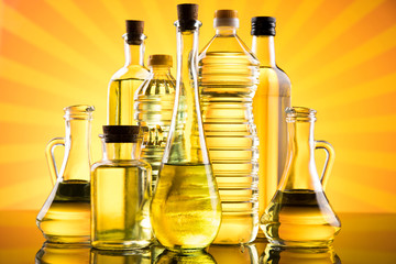 Rapeseed oil, sunflower oil, olive oil on sunburst orange background