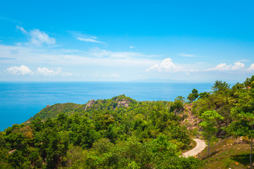 Fototapeta premium Natural Landscape View of Stone Mountain and Tropical Beach against Blue Sky and Clouds