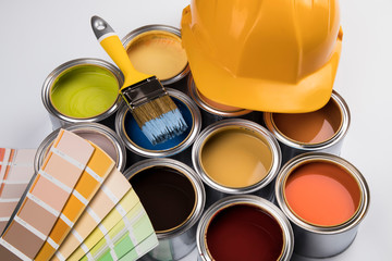 Metal tin cans with color paint and paintbrush