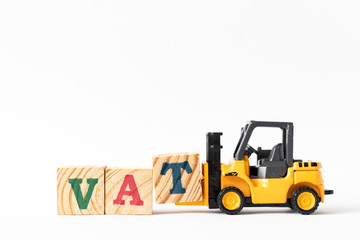 Toy forklift hold wood letter block T to complete word VAT (Abberviation of Value added tax) on white background
