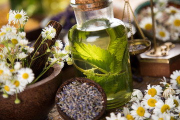 Obraz na płótnie Canvas Fresh herbs and oils, wooden table background