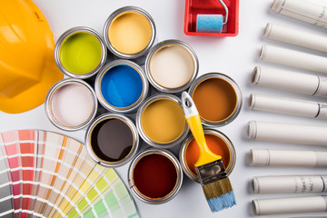 Tin cans with paint, brushes and bright palette of colors