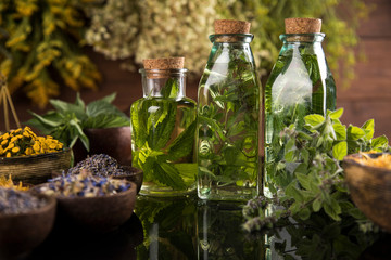 Oil and Natural medicine, wooden table background