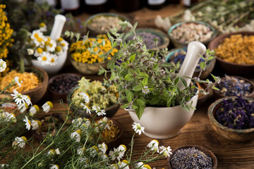 Herbs medicine and vintage wooden background
