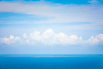 Naklejka na ściany i meble Background Texture of Ocean Skyline with Tropical Beach against Blue Sky and White Clouds in Summer Sunny Day