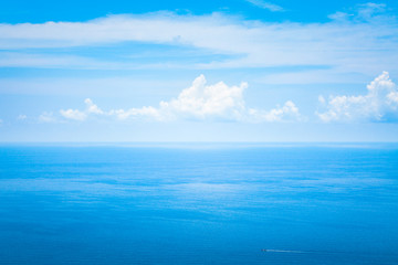 Background Texture of Ocean Skyline with Tropical Beach against Blue Sky and White Clouds in Summer Sunny Day
