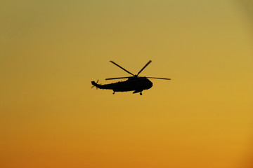 Naklejka na ściany i meble ニューヨークの夕焼け空を飛ぶヘリコプター