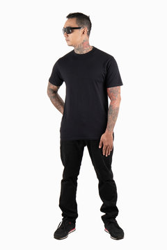 Black man tattooed wearing black t-shirt short sleeve isolated on plain background